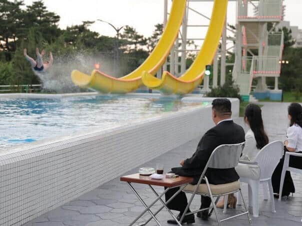 Kim sits with a drink and a cigarette, the generals run between the slide …