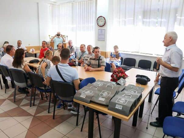 Members of the Association of Blind KS get a cell phone adapted to their needs