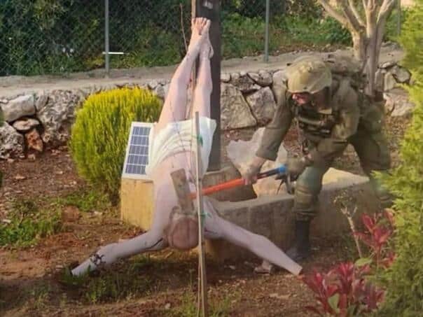 An Israeli soldier hit a statue of Jesus with a sledgehammer in southern Lebanon
